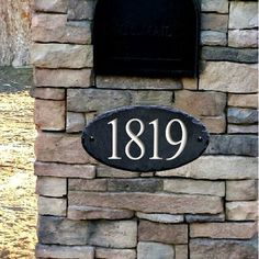 a brick wall with a plaque on it and the number 1911 written in white ink