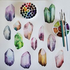 some watercolors are sitting on top of a paper