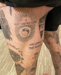 a man's legs with tattoos and words on them