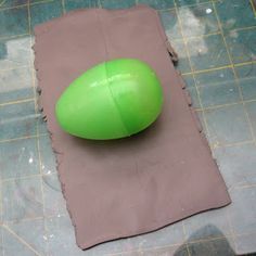 a green object sitting on top of a piece of paper