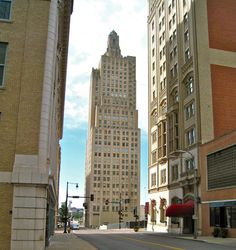 an empty city street with tall buildings in the background