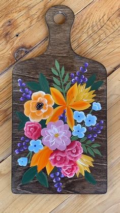 a cutting board with flowers painted on it