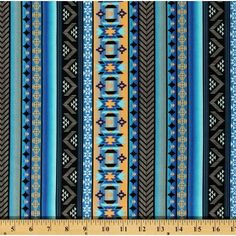 a blue and yellow striped fabric with an intricate design on the bottom, in front of a