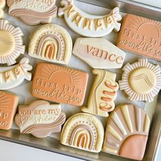 some cookies that are sitting on a tray with words and shapes around them in pastel colors