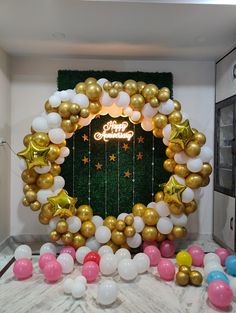 balloons and streamers are arranged around a happy new year's wreath on display