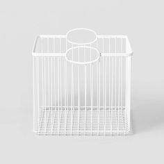 a white wire basket with two circles on the top