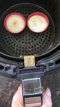 two pieces of food are being cooked in an open air fryer with the lid down