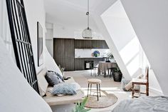 a living room filled with furniture and lots of windows