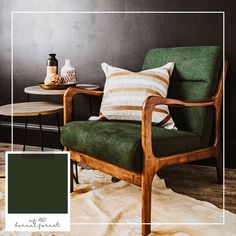 a green chair sitting on top of a rug next to a table