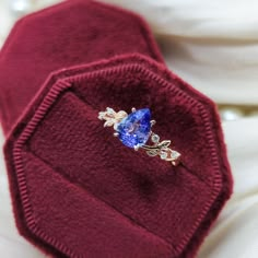 a close up of a tie with a blue stone in it's lapel