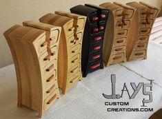 four wooden drawers are lined up on a table with the words jay's custom creations written below them