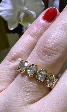 a close up of a person's hand with a diamond ring on their finger