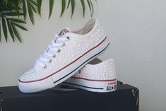 "The Converse is one size larger. Make sure you order the right size. These are custom made and non-refundable. More converse. https://www.etsy.com/shop/ZorzosCollection?ref=seller-platform-mcnav We can work with you to create the perfect dream couple of personalized wedding instructors. Choose your Converse color, your crystals, your ink color and leave the rest to us. Each order includes extra stones and original laces. If you would prefer the all white converse, please feel free to contact us Converse White Platforms With Gold Accents, Wedding Converse Clogs & Mules, Pearl Converse, All White Converse, Star Logos, Dream Couple, Bling Converse, Custom Converse, Pearl Accessories