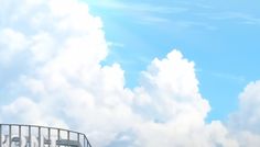 an airplane is flying in the sky over some buildings and grass with white clouds behind it