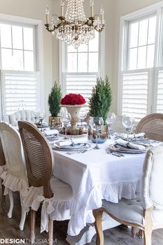 a dining room table is set with white linens