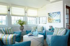 a living room filled with blue couches and chairs