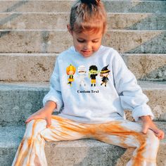 This is a custom toddler long-sleeve sweatshirt with a cute design for Halloween. Made from 100% combed ringspun cotton fine jersey, this is the perfect outfit for toddlers during the Halloween season.  .: 100% combed, ring-spun cotton (fiber content may vary for different colors) .: Light fabric (4.5 oz/yd² (153 g/m .: Toddler unisex fit .: Tear away label for kids with sensitive skin Personalize your Custom Sweatshirt: 1. Select the size and color of your sweatshirt. 2. Add your preferred text color and font in the personalization box. This is optional. 3. Enter your custom text. I will send you a prototype of the item before it goes into production. Thank you for supporting my small business! Halloween Graffiti Print Crew Neck T-shirt, Halloween Crew Neck T-shirt With Character Print, Halloween Toddler, Halloween Shirts Kids, Kids Labels, Custom Kids, Toddler Halloween, Sweatshirt Halloween, Custom Sweatshirts