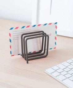 a stack of three rings sitting on top of a desk next to a computer keyboard