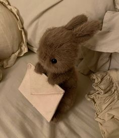 a stuffed animal is sitting on a bed