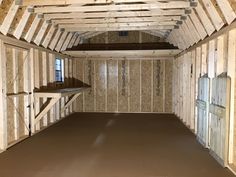 an empty room with wooden walls and flooring in the process of being built,