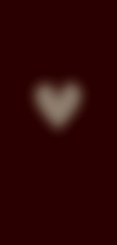 a blurry image of a heart on a dark background