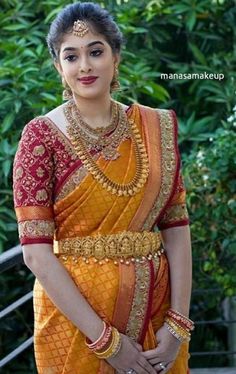 a woman in an orange and red sari