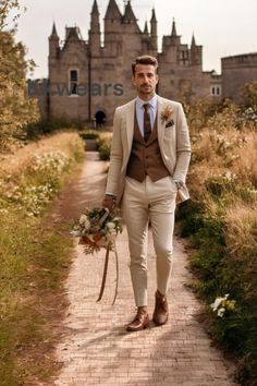 a man in a suit and tie walking down a brick path with flowers on his lapel