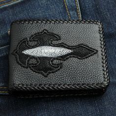 Stingray Leather Inlaid Black Cross Biker Wallet   The size measure 4" x 3.5" inches.    Provides 5 card slots, 2 bill compartments, and a pocket for change;     Beautifully embellished with black and white beads, this Stingray Leather Black Cross Bi-fold Biker Wallet for Men will add the finishing touch to any biker, rocker or trucker outfit. Handcrafted by skilled artisans with years of experience in creating one-of-a-kind leather accessories, it features a 100% genuine stingray exterior with Trucker Outfit, Note Pouch, Cross Applique, Wallet Chains, Biker Wallet, Wallet For Men, Black Cross, Belt Accessories, Wallet Chain