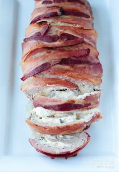 bacon wrapped in bread on a white plate