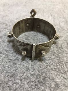 A superb old Berber silver bracelet from Morocco. The surface of the bangle has been finely hand-etched with a design combining lines, and the surface as well as interior have both obtained a very rich patina from wear and usage. It opens and closes with a pin. Inner diameter : 6,5cm Width : 3cm Weight : 80,4g Traditional Engraved Sterling Silver Bracelet For Ceremonial Use, Bohemian Engraved Sterling Silver Bracelet For Ceremonial Use, Bohemian Engraved Sterling Silver Bracelet For Ceremonial Occasions, Bohemian Engraved Sterling Silver Bracelet For Ceremonies, Artisan Engraved Bracelets For Festivals, Traditional Engraved Sterling Silver Bangle Bracelet, Traditional Engraved Sterling Silver Bangle, Traditional Ceremonial Stamped Bangle, Traditional Stamped Sterling Silver Bangle