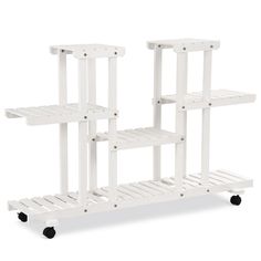 three white shelving units on wheels against a white background