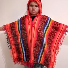 This Poncho Woven In Multicolor Wool, The Poncho Is Used By People Of The Andean Community To Protect Themselves From The Intense Cold In The Winter, It Can Also Be Seen In The Images That It Has A Hood Or Cap And Is Large Size Handmade By The Artisans Of The City Of Cusco Measure 39" X 62" Traditional Red Poncho For Fall, Traditional Red Fall Poncho, Red Long Sleeve Poncho, One Size, Red Poncho For Festival In Fall, Traditional Red One-size Poncho, Red Poncho For Beach In Fall, Red Fall Festival Poncho, Red Long Sleeve Poncho For Festival, Red Bohemian Hooded Poncho