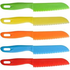 four different colored plastic knives on a white background