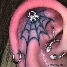 the ear is decorated with spider web designs