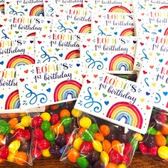 birthday cards with rainbows and hearts on them in cellophane bags next to gummy candies