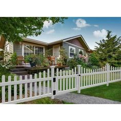 a white picket fence in front of a house