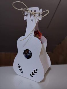 a white guitar shaped gift bag filled with candy