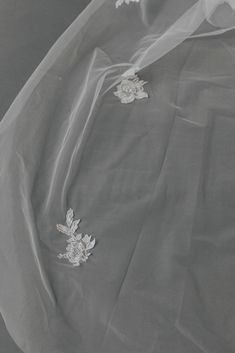 an image of white fabric with flowers on it