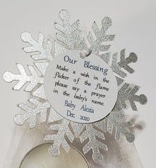 a snowflake ornament with a baby's name on it