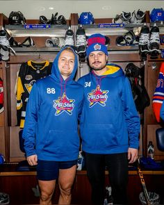 two hockey players are standing in front of lockers