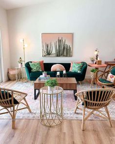 a living room filled with lots of furniture next to a painting on the wall above a coffee table