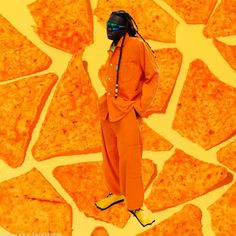 a man in an orange suit and goggles standing next to tortilla chips