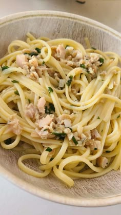 a bowl filled with pasta and meat on top of a table