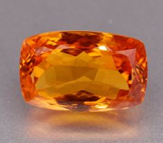 an orange diamond sitting on top of a table