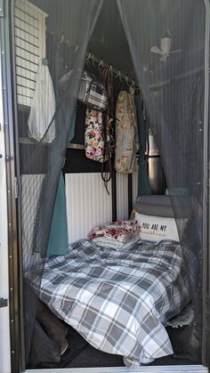 a bed in the back of a truck with mosquito netting