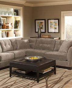 a living room scene with focus on the sectional sofa and coffee table in the middle