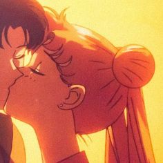 two people kissing each other in front of a yellow background with the sun shining on them