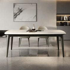 a dining room table and chairs in front of a white wall with marble flooring