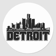 the detroit skyline in black and white on a round sticker, with the word detroit written