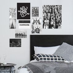 a black and white bedroom with pictures on the wall above the bed, next to a night stand